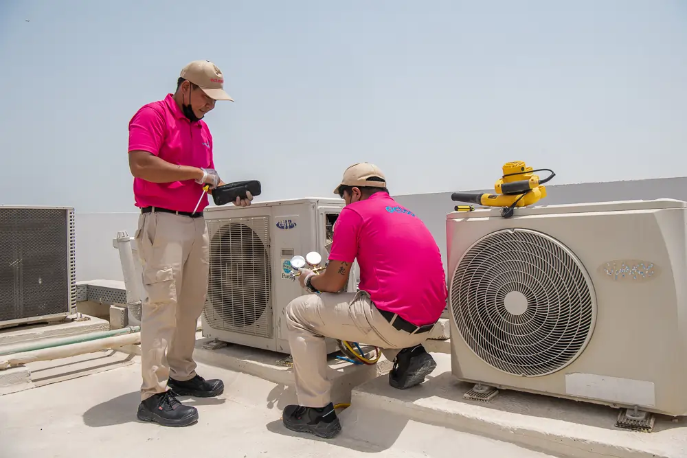 Ac Maintenance Services In Dubai Octopus Home Maintenance Technician Repairing an AC in Dubai